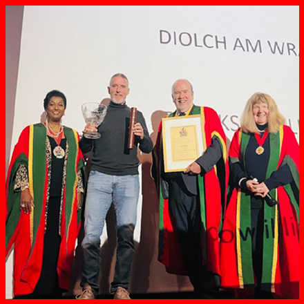 Outstanding Achievement Award Winner 2025-2026, Iolo Tudor Williams receiving his award from The Master Henry Gilbert